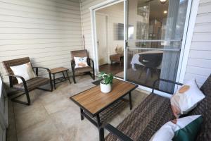 a porch with chairs and a table and a table at Nomad Retreat King Bed Boutique Condo w Garage in Gainesville