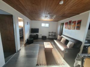 a living room with a couch and a table at RyG Apartments in San Carlos de Bariloche