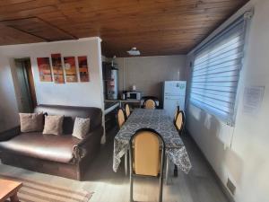 a living room with a table and a couch at RyG Apartments in San Carlos de Bariloche