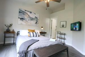 a bedroom with a bed and a ceiling fan at Renovated Modern Industrial Suite 2 BR Condo in Gainesville