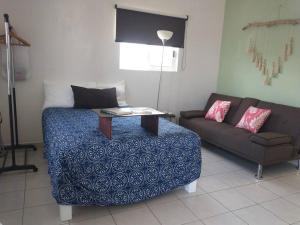 a living room with a bed and a couch at Departamento Palmita in La Paz