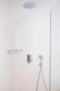 a shower with a glass door and a shower head at Villa privada en Corralejo in Corralejo