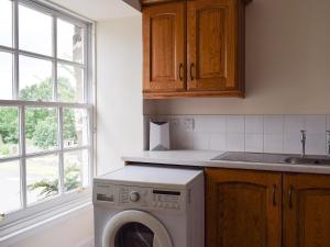 a kitchen with a washing machine and a sink at Easter Baldinnies in Forteviot