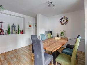 a dining room with a wooden table and chairs at Holiday home in Feld am See with terrace in Feld am See