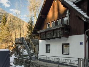 a house with a balcony on the side of it at Holiday home in Feld am See with terrace in Feld am See