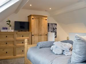 a bedroom with a bed with a tv and a dresser at Hidden Gem in Willingham