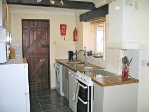 a kitchen with a sink and a stove top oven at The Granary in Knapton