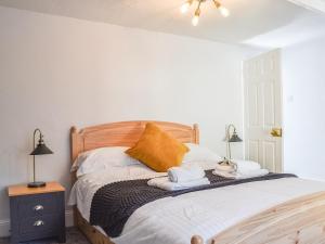 a bedroom with a bed with towels on it at Church View in Lynmouth