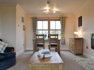 a living room with a table and a dining room at Beith in Kilmuir