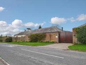 a brick house with a gate on a street at Graces Retreat in Eryholme