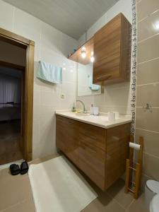 a bathroom with a sink and a toilet and a mirror at Luxury apartment with sea view in Mezitli