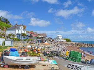 a group of boats on the shore of a beach at Old School Mews in Shanklin