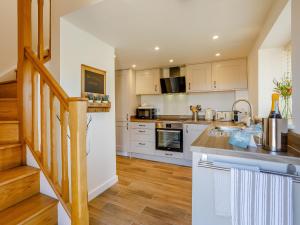 a kitchen with white cabinets and a counter top at Knoll Cottage - Uk31171 in Brent Knoll