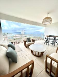 a living room with a view of the ocean at Bella Apartment in Fort-de-France