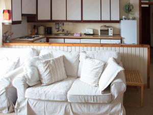 a white couch in front of a kitchen at Uk13327 Stables in Rosemarkie