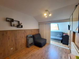 a living room with a couch and a chair at Studio Bolquère-Pyrénées 2000, 1 pièce, 3 personnes - FR-1-592-60 in Font-Romeu