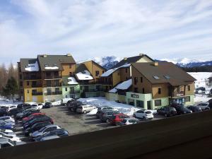 a parking lot with cars parked in front of buildings at Studio Bolquère-Pyrénées 2000, 1 pièce, 3 personnes - FR-1-592-60 in Font-Romeu