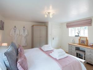 um quarto com uma cama com toalhas em The Shambles em Fulletby