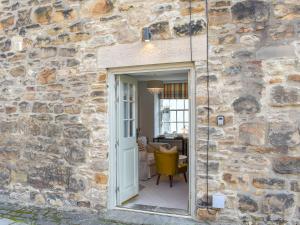 a stone building with a door leading into a room at Gadir in Hexham