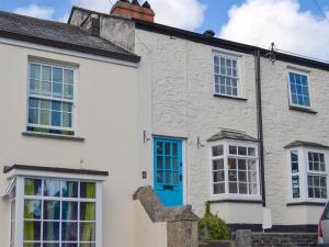 a white house with blue doors and windows at Duke Street in Lostwithiel