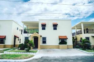 a large white house with a driveway at Breathtaking Oceanfront in Portmore