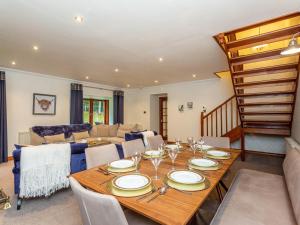 a dining room with a wooden table and chairs at The Old Boathouse in Cromdale