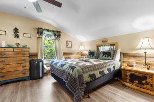 a bedroom with a bed and a dresser at Bears Tree 2 in Sevierville