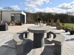 a stone table and benches in a courtyard at Park Barn in Whittington