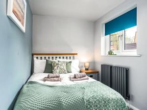 a bedroom with a large bed with two pillows on it at Plum Tree House in Dore