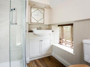a bathroom with a sink and a shower at Garden Cottage in Settrington