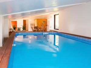 a large swimming pool with blue water in a house at Swallows Folly-uk38278 in Cloughton