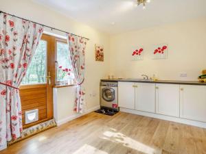 a kitchen with a washing machine and a window at Y Buedy - Uk40699 in Lampeter