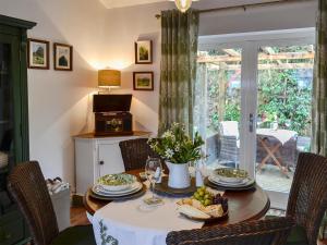 a dining room with a table and chairs and a window at The Lodge in Dyserth