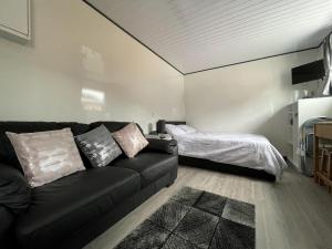 a living room with a couch and a bed at Uist - Uk34049 in Stornoway