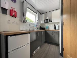 a kitchen with gray cabinets and a counter top at Uist - Uk34049 in Stornoway