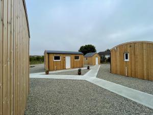 a row of wooden buildings in a field at Uist - Uk34049 in Stornoway