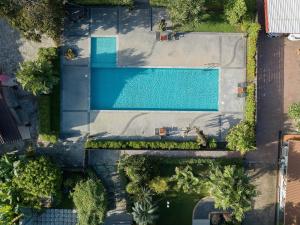 an overhead view of a swimming pool with trees at Picha Ville Resort in Watthana Nakhon