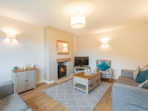 a living room with a couch and a fireplace at Carr View Farm in Bamford