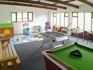 a room with a foosball table and other play equipment at The Mealhouse-UK12902 in Pelynt