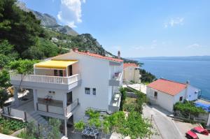 a white house with a view of the ocean at Apartments Zorka Leko in Omiš