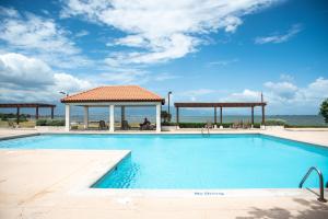 a swimming pool with a gazebo next to the ocean at Breathtaking Oceanfront in Portmore