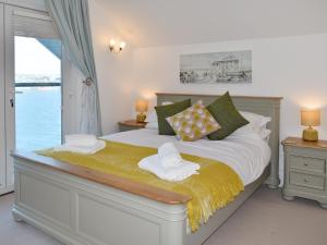 a bedroom with a large bed with a window at Kings Haven in Turnchapel