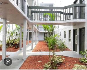 an empty courtyard of a building with a walkway at Shining Star in West Palm Beach
