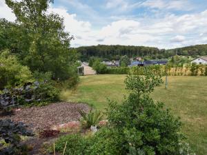 a view of a garden with a field and houses at Cottage in Germany with Sun Terrace & BBQ in Berlingen +20 photos
