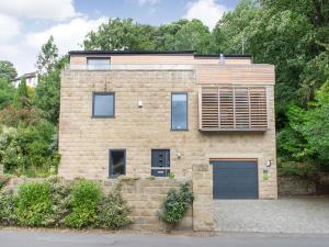 a brick house with a window and a garage at High Trees View in Knaresborough