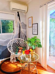 a swing in a room with a glass table at 11 chartwell in Brisbane