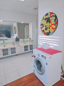 a washing machine in a kitchen with a mirror at 11 chartwell in Brisbane