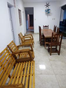 a dining room with wooden benches and a table at el mistol in San Miguel de Tucumán