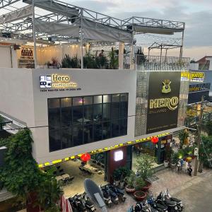 a large building with motorcycles parked in front of it at Hero Hostel & Billiards in Chau Doc