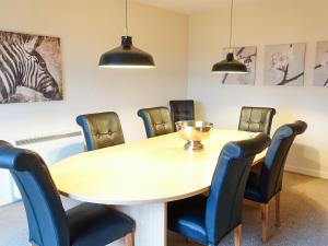 a conference room with a table and chairs at Seaforth Cottage in Cononbridge